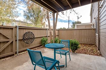A patio with a table and two chairs.